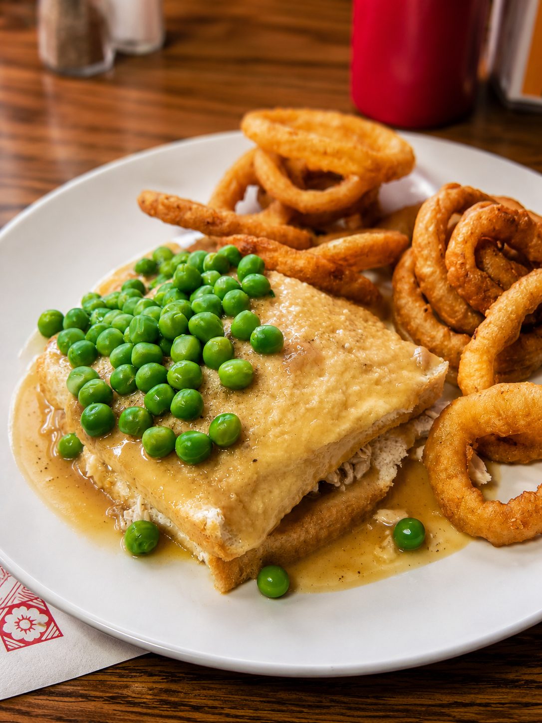 Hot chicken plate with peas and onion rings