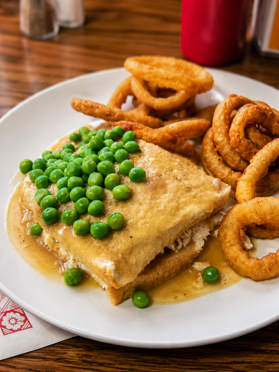 Hot chicken plate with peas and onion rings